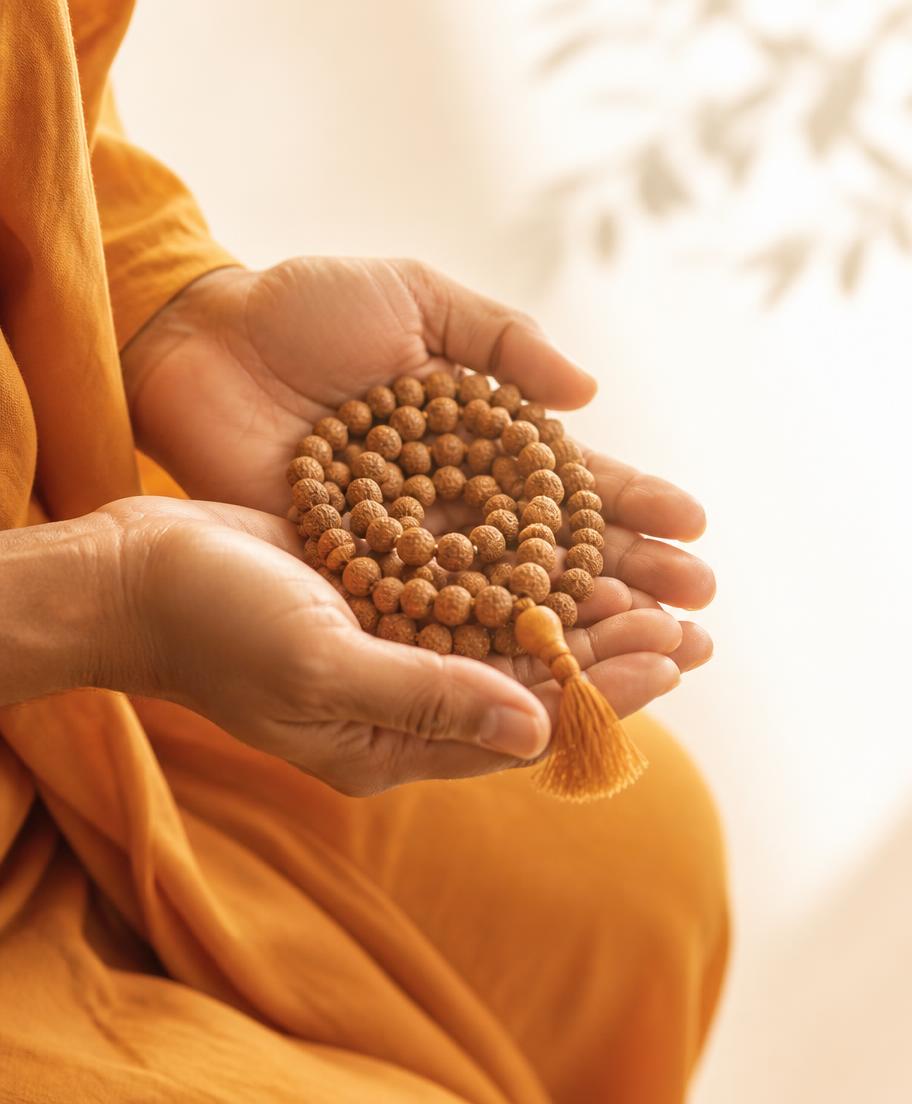 Japa meditation beads held in cupped hands